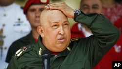 Venezuela's President Hugo Chavez touches his head as he speaks to the media in Caracas September 17, 2011, before heading to Cuba for more chemotherapy.