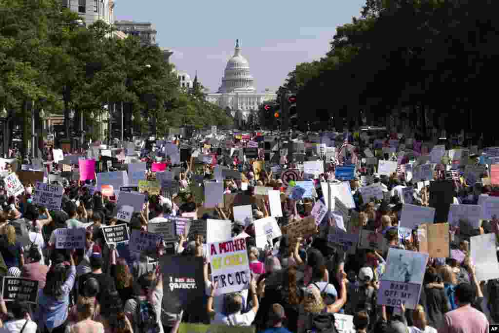 With the U.S Capitol in the background, thousands of demonstrators march on Pennsylvania Avenue during the Women&#39;s March in Washington, Oct. 2, 2021.