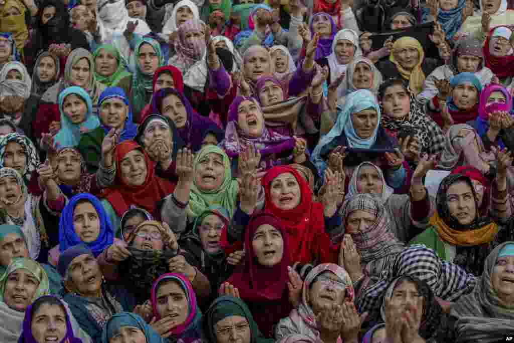 Kashmiri Muslim devotees raise their hands in prayer as a head priest displays a relic of Prophet Muhammad at the Hazratbal shrine on Eid-e-Milad, or the birth anniversary of Prophet Muhammad, in Srinagar, Indian-controlled Kashmir.