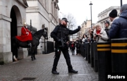 Armed police patrol busy public areas around Westminster as security is stepped up ahead of New Year's Eve celebrations in London, Britain, Dec. 31, 2017.