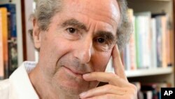 FILE - In this Sept. 8, 2008 file photo, author Philip Roth poses for a photo in the offices of his publisher Houghton Mifflin, in New York. 