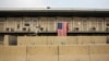 FILE - A U.S. flag hangs on a housing unit inside of Bagram Airfield in the Parwan province of Afghanistan, Jan. 2, 2015. According to numbers provided late last year by the outgoing Obama administration, the U.S. is maintaining approximately 8,400 troops in Afghanistan.