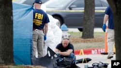 FBI crime scene investigators document the area around an allegedly Islamic State-inspired shooting in Garland, Texas, May 4, 2015.