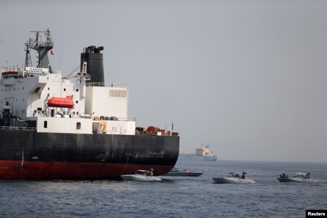 UAE Navy boats are seen next to Al Marzoqah, Saudi Arabian tanker, off the Port of Fujairah, UAE, May 13, 2019.
