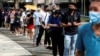 FILE - People queue up outside a quick test center to take their coronavirus disease (COVID-19) antigen rapid tests, in Singapore, Sept. 21, 2021.