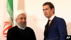 El presidente iraní, Hassan Rouhani, estrecha la mano del canciller de Austria, Sebastian Kurz, en la cancillería federal de Viena, Austria, el miércoles 4 de julio de 2018. (AP Photo / Ronald Zak). La UE implementará el martes 7 de agosto de 2018 una ley para proteger a las empresas europeas de los efectos extraterritoriales de las sanciones de EE.UU. a Irán.