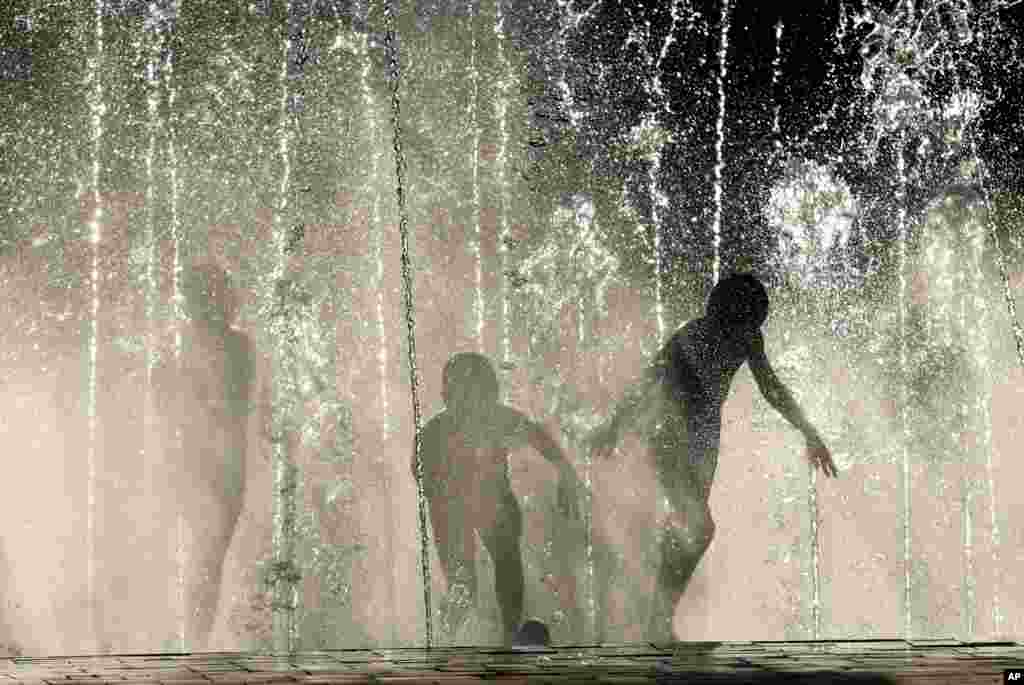 Children play in a city fountain in Volgograd, Russia.