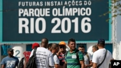 Striking workers stand in front the entrance of the Olympic Park, the main cluster of venues under construction for the 2016 Summer Olympic Games, in Rio de Janeiro, April 8, 2014. 