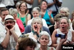 FILE - People shout at a town hall meeting on health care reform hosted by Rep. Mike Coffman, R-Colo., in Littleton, Colorado, Aug. 12, 2009.