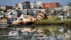 In this photo taken Monday, Oct. 1, 2018, containers used for hazardous chemicals lie exposed and piled up at a junkyard run by the Chinese-led Dar Petroleum Operating Company in Gumry, near Paloch, in South Sudan.
