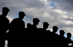 FILE - US soldiers stand in formation during a military ceremony at the Storck barracks in Illesheim, Germany.