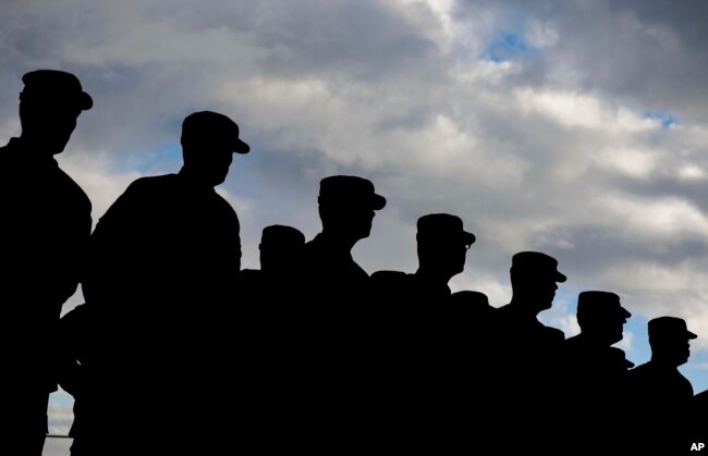 FILE - US soldiers stand in formation during a military ceremony at the Storck barracks in Illesheim, Germany.