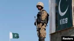 FILE - A Pakistani soldier stands guard at the Angoor Adda outpost along Pakistan's border with Afghanistan, in South Waziristan, Pakistan Oct. 18, 2017.