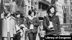 Four Chinese American girls carrying ice skates in Chinatown, New York City (April 27, 1965)