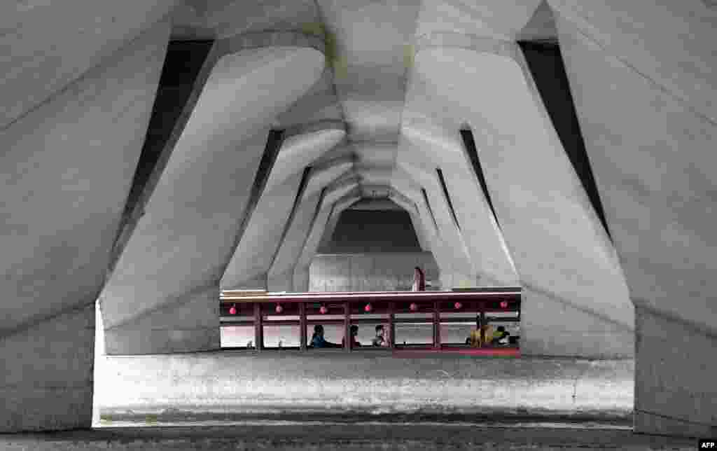 A tourist boat goes under the Nicoll bridge at Elizabeth Walk in Singapore.