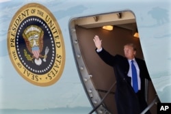 President Donald Trump waves while boarding Air Force One for a trip to Vietnam to meet with North Korean leader Kim Jong Un in Andrews Air Force Base, Maryland, Feb. 25, 2019.