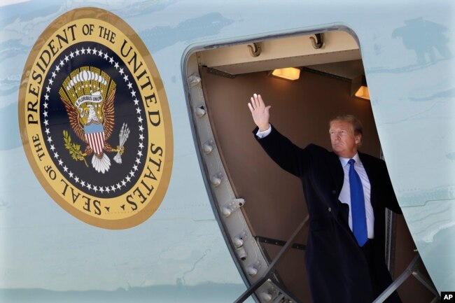 President Donald Trump waves while boarding Air Force One for a trip to Vietnam to meet with North Korean leader Kim Jong Un in Andrews Air Force Base, Maryland, Feb. 25, 2019.