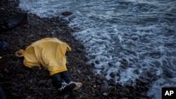 FILE - Plastic sheeting covers the body of an unidentified boy near Skala, a village on the Greek island of Lesbos, Nov. 1, 2015. He was among nearly 4,000 to die in attempted Mediterranean crossings this year. 