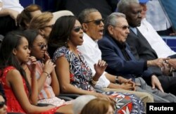 U.S. President Barack Obama and his family react along with Cuban President Raul Castro