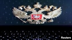 The coat of arms of Russia is reflected in a laptop screen in this picture illustration taken Feb. 12, 2019. 