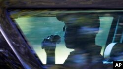 President Barack Obama is seated in the presidential vehicle as his motorcade leaves after playing a round of golf at Farm Neck Golf Course in Oak Bluffs, Massachusetts, on Martha's Vineyard, Aug. 18, 2016.