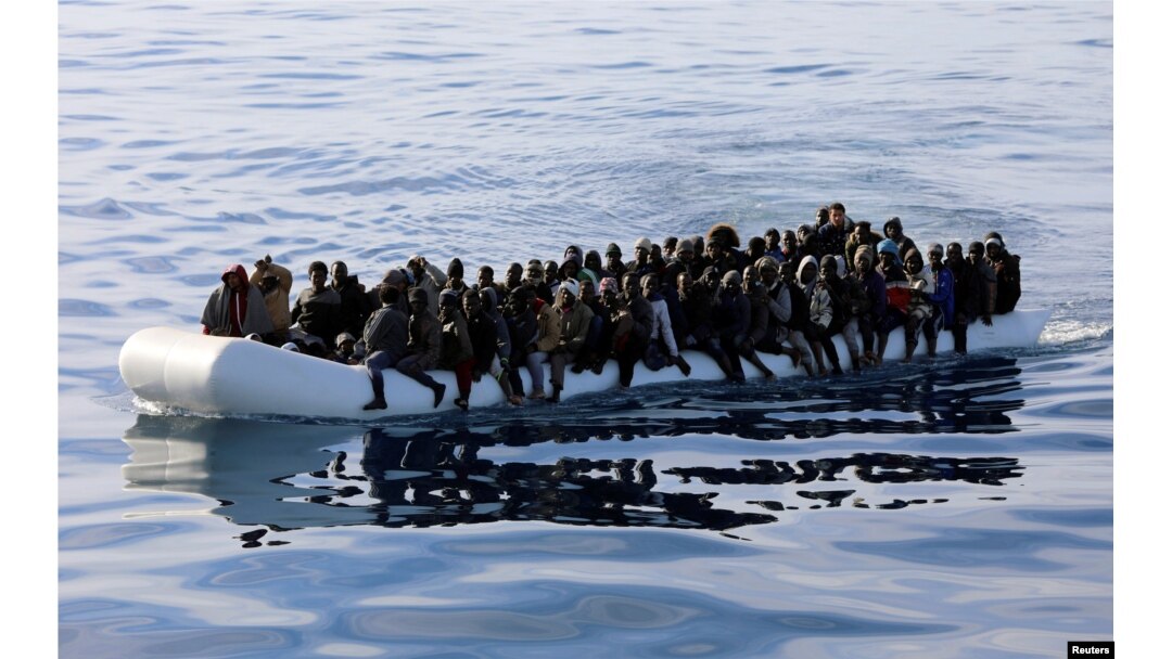 FILE - Migrants are seen in a rubber dinghy as they are rescued by the Libyan coast guard in the Mediterranean Sea off the coast of Libya, Jan. 15, 2018.
