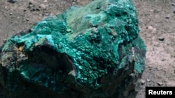 A piece of malachite, a copper ore, is seen at the bottom of Congolese state mining company Gecamines' Kamfundwa open pit copper mine, Jan. 31, 2013. 