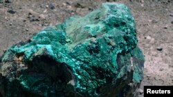 FILE: A piece of malachite, a copper ore, is seen at the bottom of Congolese state mining company Gecamines' Kamfundwa open pit copper mine, Jan. 31, 2013. 