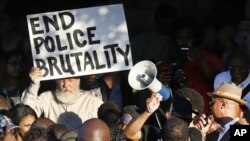 Demonstrators gather near a community pool during a protest Monday, June 8, 2015, in response to an incident at the pool involving McKinney police officers in McKinney, Texas.