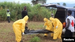 FILE - Health workers carry the body of an Ebola virus victim in the Waterloo district of Freetown, Oct. 21, 2014. 