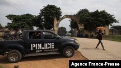 A police truck is stationed outside the University of Abuja Staff Quarters gate where unknown gunmen kidnapped two university professors, lecturers and their family members in Abuja, Nigeria, Nov. 2, 2021.