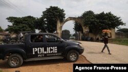 A police truck is stationed outside the University of Abuja Staff Quarters gate where unknown gunmen kidnapped two university professors, lecturers and their family members in Abuja, Nigeria, Nov. 2, 2021.
