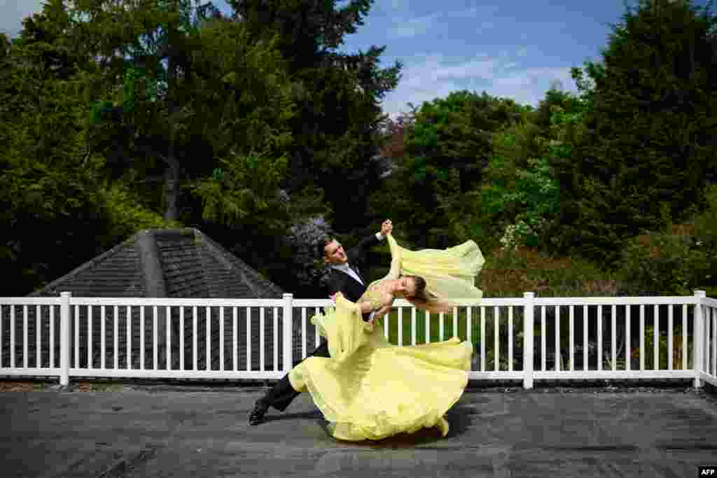 Ballroom dancers Roman Sukhomlyn and India Phillips, the North of England Champions at the British National Dance Championships, practice on their balcony at home during the lockdown due to the novel coronavirus pandemic, in Wolverhampton, central England.