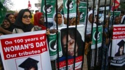 FILE - People rally demanding the release of Aafia Siddiqui, who was convicted in February 2010 of two counts of attempted murder, and who is currently being detained in the US during International Women's Day in Karachi, Pakistan, March 8, 2011.