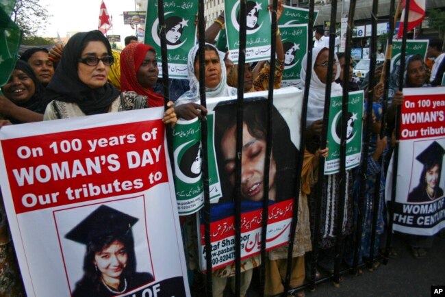 FILE - People rally demanding the release of Aafia Siddiqui, who was convicted in Feb. 2010 of two counts of attempted murder, and who is currently being detained in the U.S., during International Women's Day in Karachi, Pakistan, March 8, 2011.