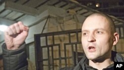 Russian opposition leader Sergei Udaltsov greets his supporters after he was released from a detention center in Moscow, Jan. 4, 2012.