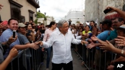 FILE - Mexico's President-elect Andres Manuel Lopez Obrador greets supporters in Mazatlan, Mexico, Sept. 16, 2018.