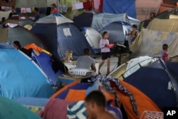 n this March 8, 2018 photo, tents fill the Tancredo Neves Gymnasium that is operating as a shelter for Venezuelans in Boa Vista, Roraima state, Brazil.