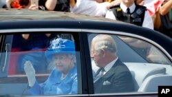 Britain's Queen Elizabeth II leaves Buckingham Palace with Prince Charles to travel to parliament for the state opening of Parliament in London, June 21, 2017.