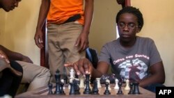 Phiona Mutesi jouant aus échecs avec ses camarades de classe à Kibuye, Kampala, le 26 janvier 2015. 