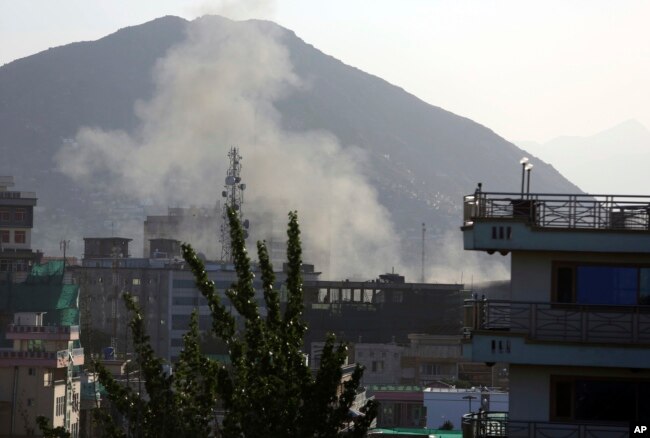 Smoke rises from the site of the second deadly suicide attack on police stations in one day, May 9, 2018, in Kabul, Afghanistan. The Taliban claimed responsibility for the series of attacks.