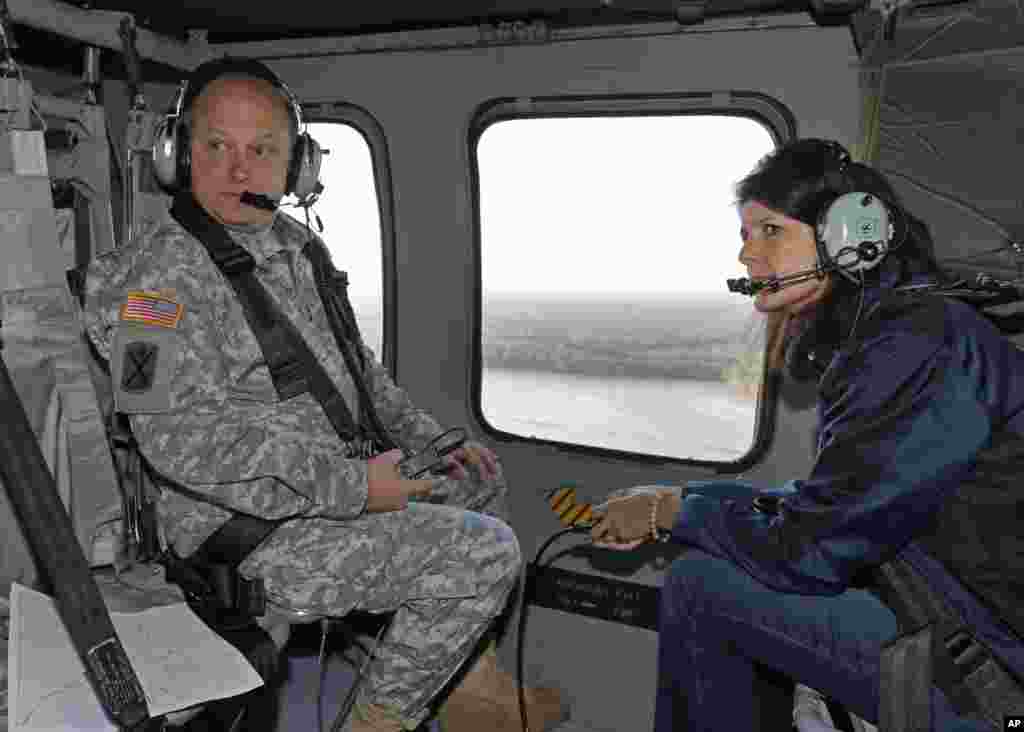 South Carolina Gov. Nikki Haley, right, and Major Gen. Bob Livingston, left, view flood damage from a helicopter in Columbia, S.C., Oct. 6, 2015. 
