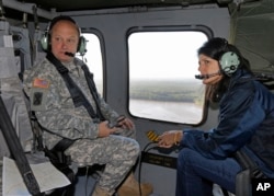 FILE - South Carolina Gov. Nikki Haley, right, and Major Gen. Bob Livingston, left, view flood damage from a helicopter in Columbia, S.C., Oct. 6, 2015.