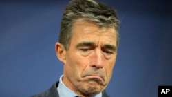 NATO Secretary General Anders Fogh Rasmussen pauses as he answers reporters' questions following a meeting of the North Atlantic Council in Brussels on Wednesday, June 4, 2014
