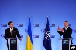 NATO Secretary General Jens Stoltenberg, right, and Ukraine's Foreign Minister Dmytro Kuleba participate in a media conference at NATO headquarters in Brussels, Belgium, April 13, 2021.