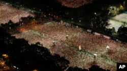 Tens of thousands of people attend a candlelight vigil at Victoria Park in Hong Kong, June 4, 2014, to mark the 25th anniversary of the Chinese military crackdown on the pro-democracy movement in Beijing. 