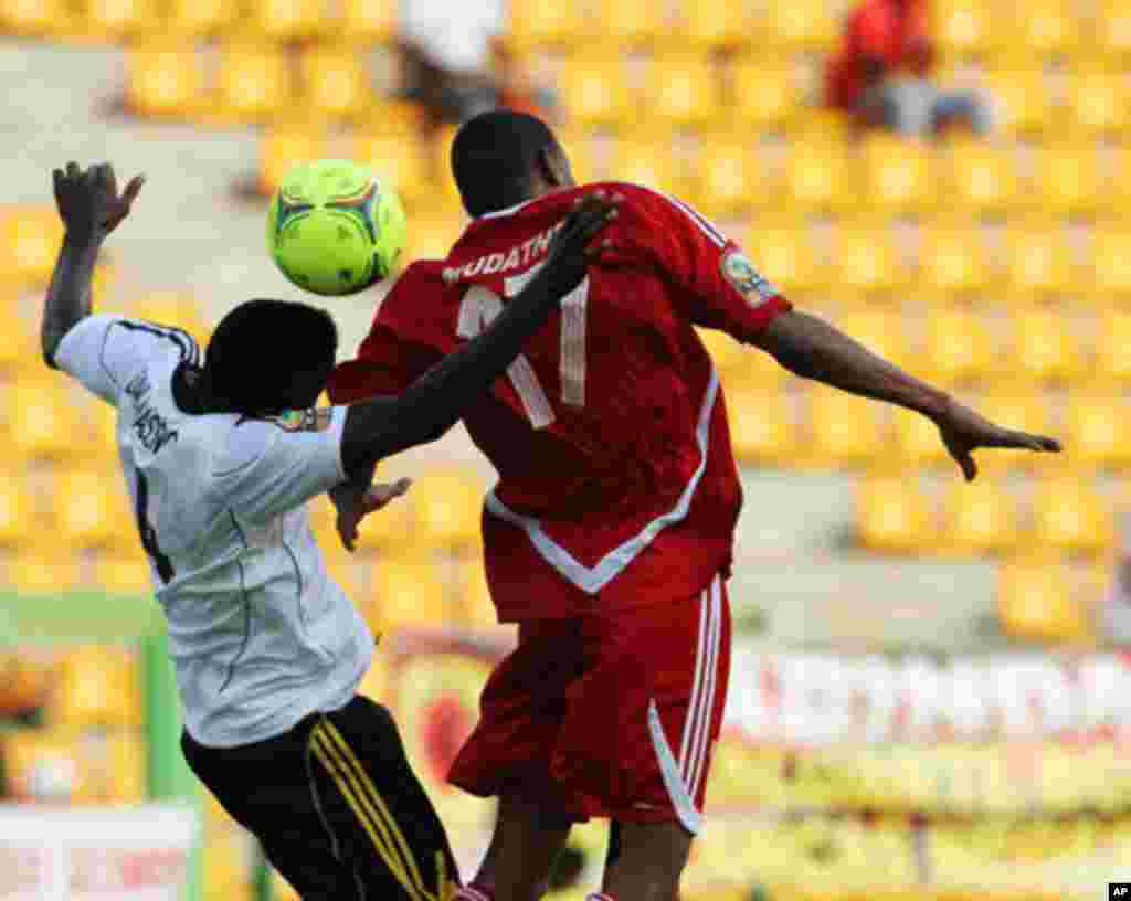 Massunguna of Angola fights for the ball with Ibrahim of Sudan during their African Nations Cup soccer match in Malabo