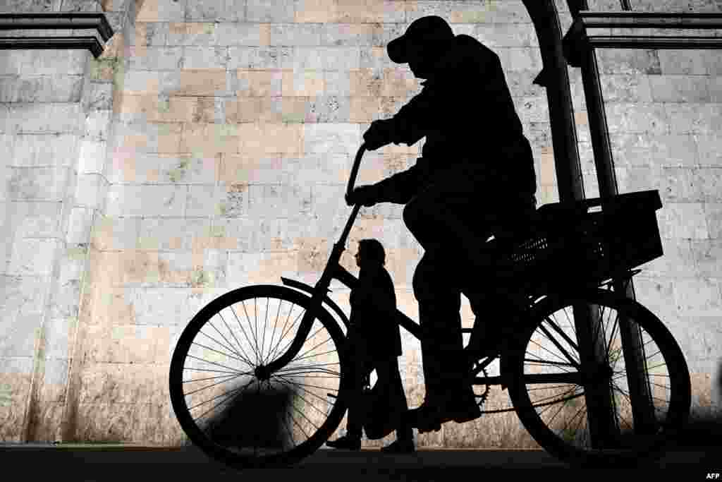 A man rides a bicycle during a sunny morning in central Moscow, Russia.