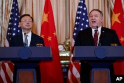 FILE - Secretary of State Mike Pompeo, right, joined by Chinese Politburo Member Yang Jiechi, speaks during a news conference at the State Department in Washington, Nov. 9, 2018.