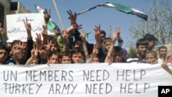 Handout photo released by Shaam News Network shows an anti-Assad demonstration in Hass in Idlib province on April 20, 2012.